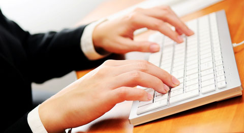 Girl typing on a keyboard